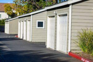 Freshly paved asphalt driveway and residential garage access road in a Bay Area housing community with clean pavement and curb lines.